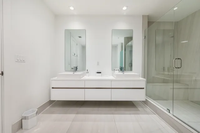 a bathroom with double vanity sink and mirror