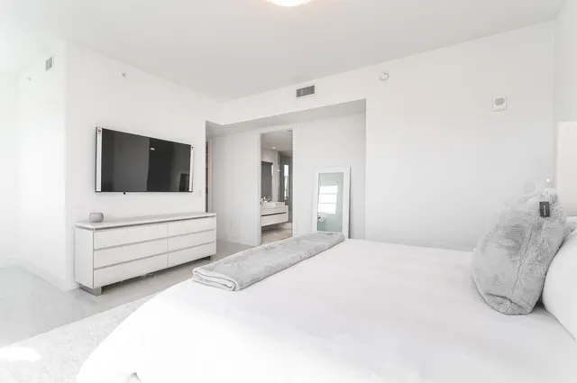 a room with a bed and a television