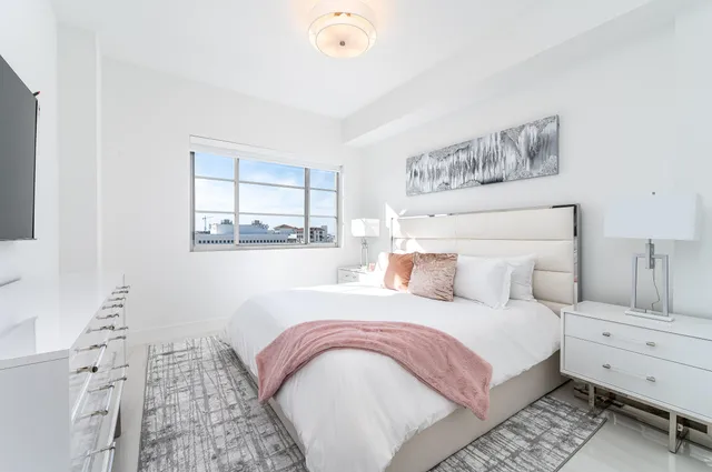 a bedroom with a bed and a painting on the wall