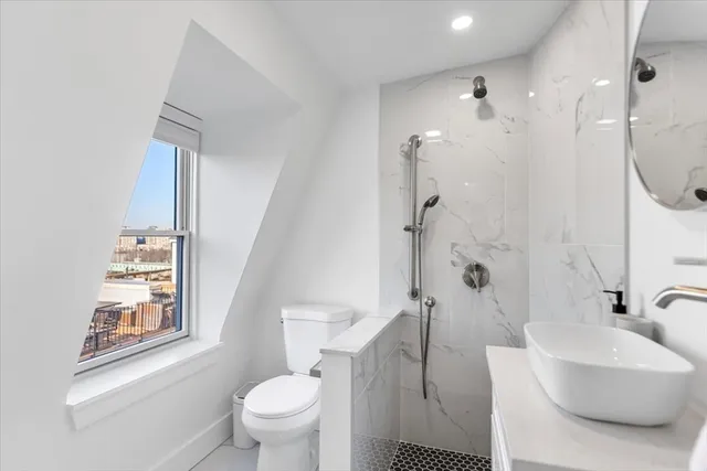 a bathroom with a sink toilet and shower