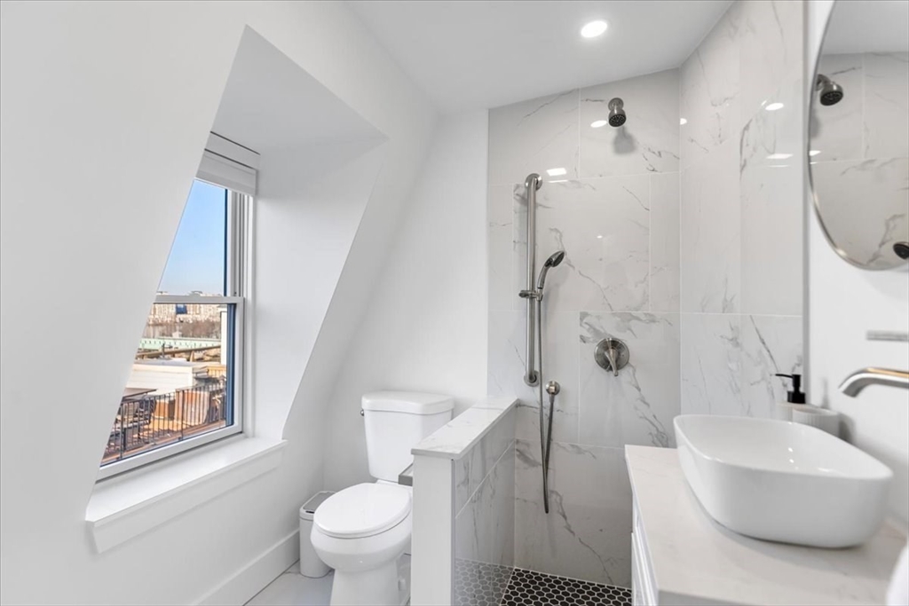 6 Goodwin Place, Unit 4 Boston, MA 02114 - Photo 13 of 24 a bathroom with a sink toilet and shower