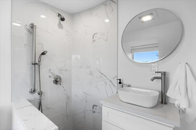 a bathroom with a sink a toilet and a mirror