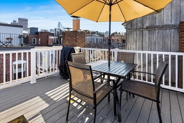 a view of a roof deck with furniture