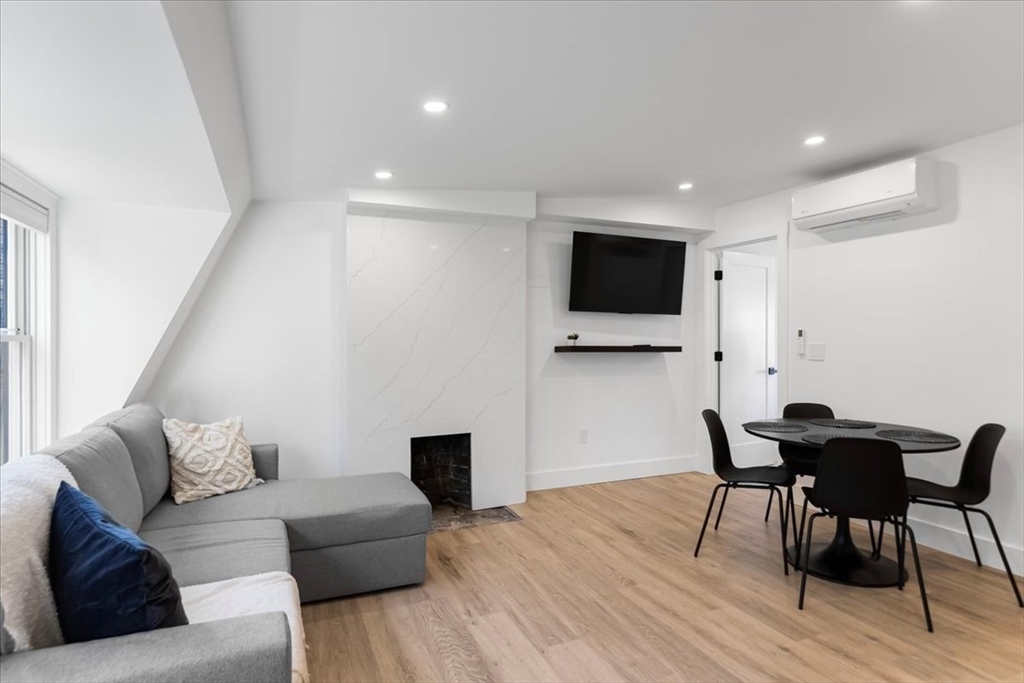 6 Goodwin Place, Unit 4 Boston, MA 02114 - Photo 9 of 24 a living room with furniture and a flat screen tv