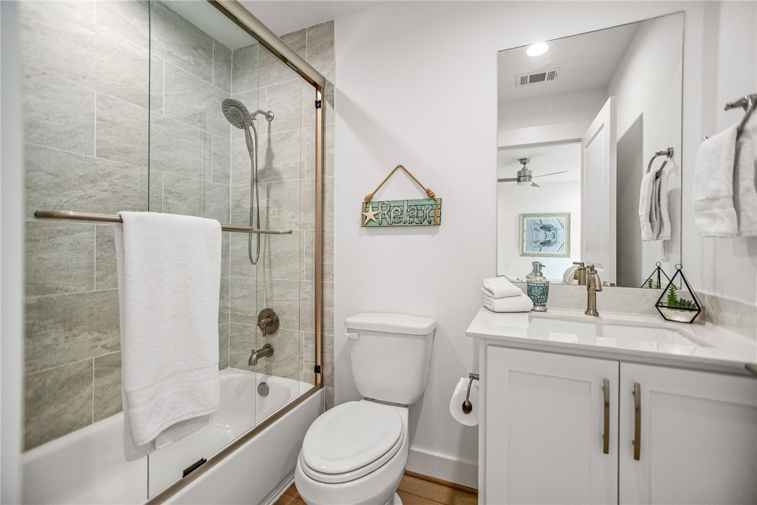 96 Circle Hook Port O'Connor, TX 77982 - Photo 22 of 36 a bathroom with a granite countertop sink toilet and shower