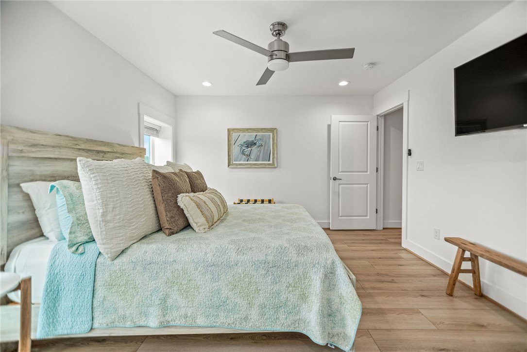 96 Circle Hook Port O'Connor, TX 77982 - Photo 28 of 36 a bedroom with a bed and a flat screen tv