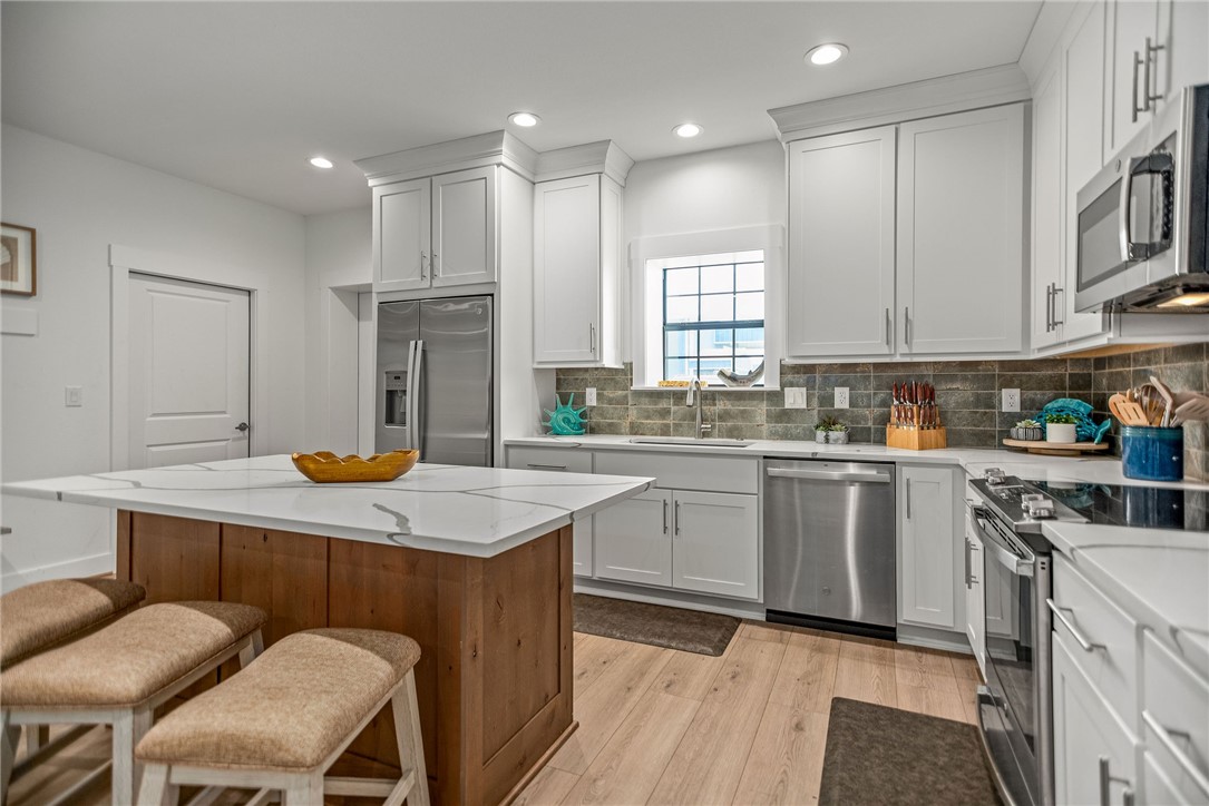 96 Circle Hook Port O'Connor, TX 77982 - Photo 7 of 36 a kitchen with a sink a window and chairs