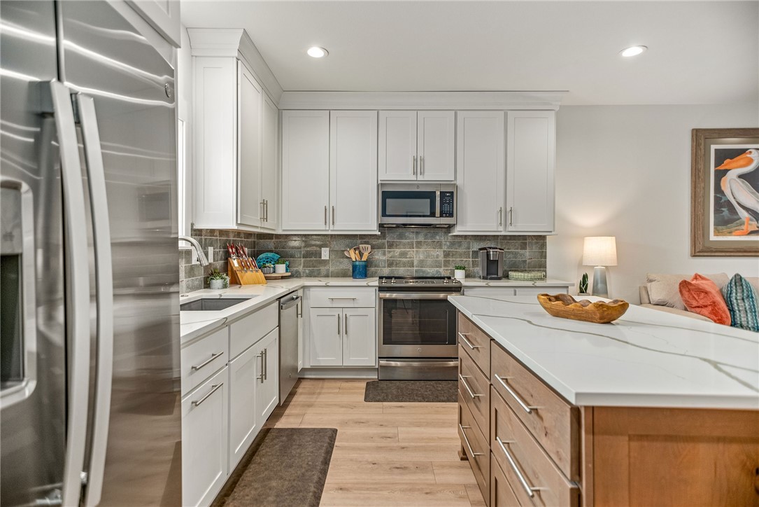 96 Circle Hook Port O'Connor, TX 77982 - Photo 8 of 36 a kitchen with stainless steel appliances granite countertop a refrigerator sink and stove