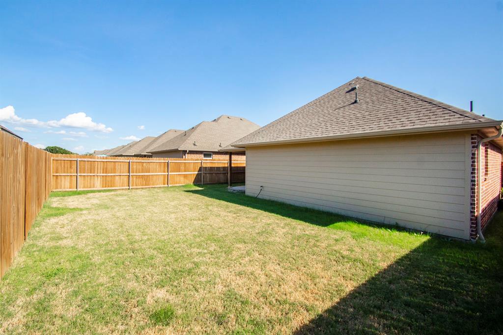 806 Ransom Way Greenville, TX 75402 - Photo 26 of 27 Expansive grassy yard with a wood privacy fence