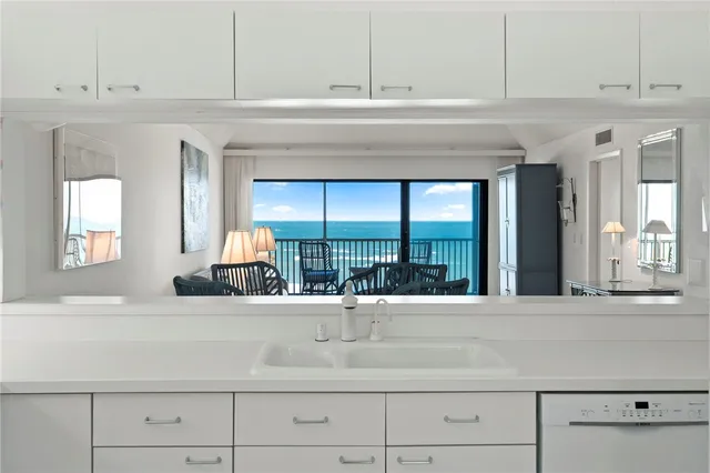 a living room with a sink and a large mirror