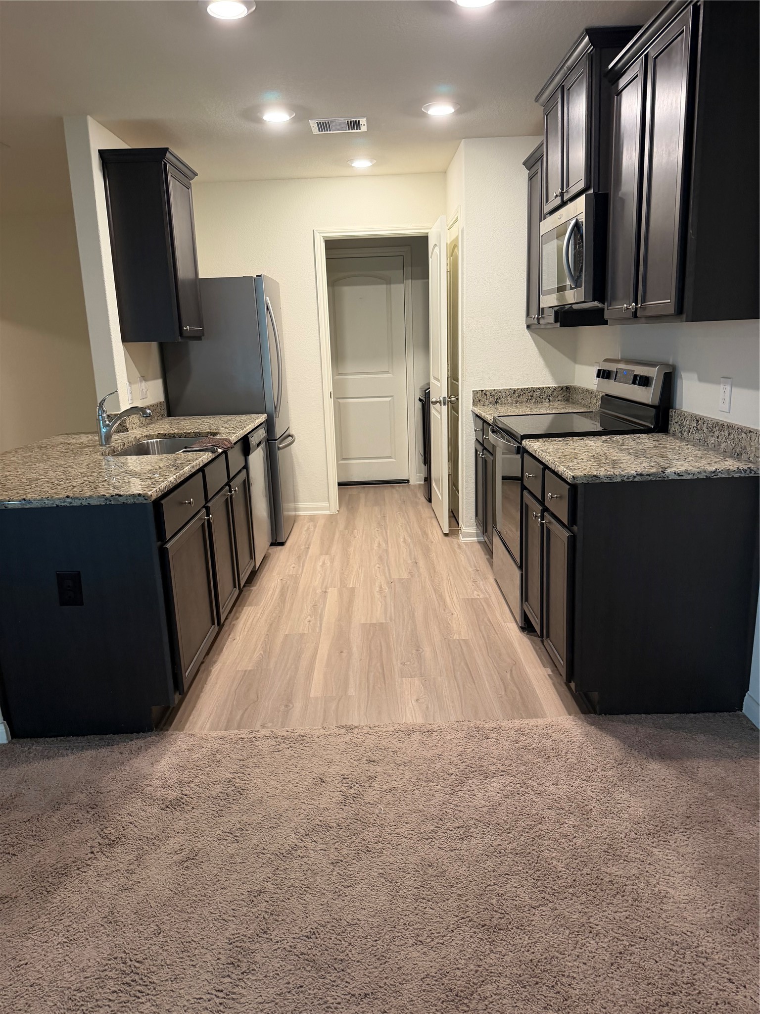 8410 Dusty Ridge Road Baytown, TX 77523 - Photo 11 of 18 a kitchen with stainless steel appliances granite countertop a sink stove and refrigerator