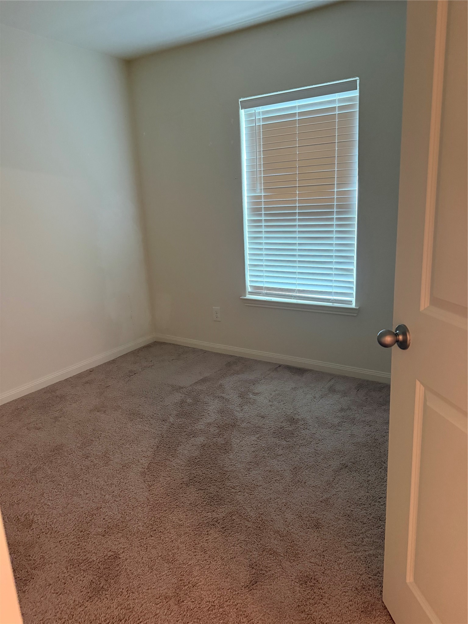 8410 Dusty Ridge Road Baytown, TX 77523 - Photo 12 of 18 an empty room with a window