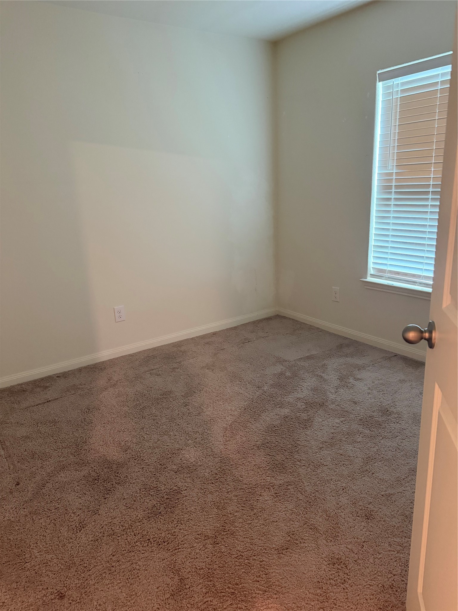 8410 Dusty Ridge Road Baytown, TX 77523 - Photo 13 of 18 an empty room with a window