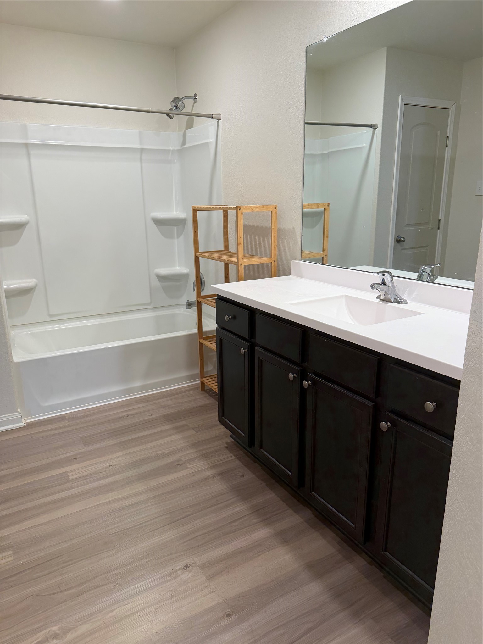 8410 Dusty Ridge Road Baytown, TX 77523 - Photo 5 of 18 a bathroom with a double vanity sink a mirror and a bathtub