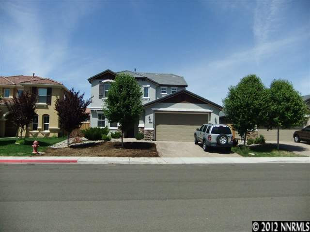 a view of house and car parked in front of house