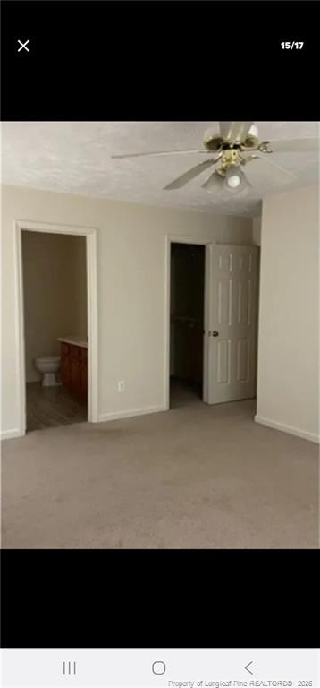 a view of an empty room with a kitchen