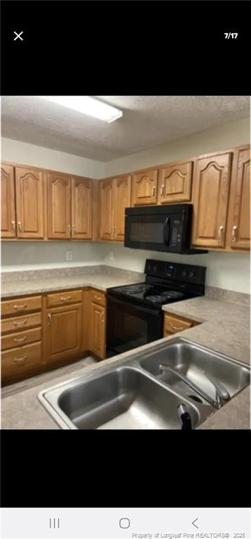 2009 Sardonyx Road, Unit 2 Fayetteville, NC 28303 - Photo 7 of 15 a kitchen with a sink and cabinets