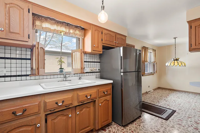 a kitchen with stainless steel appliances granite countertop a refrigerator and a sink