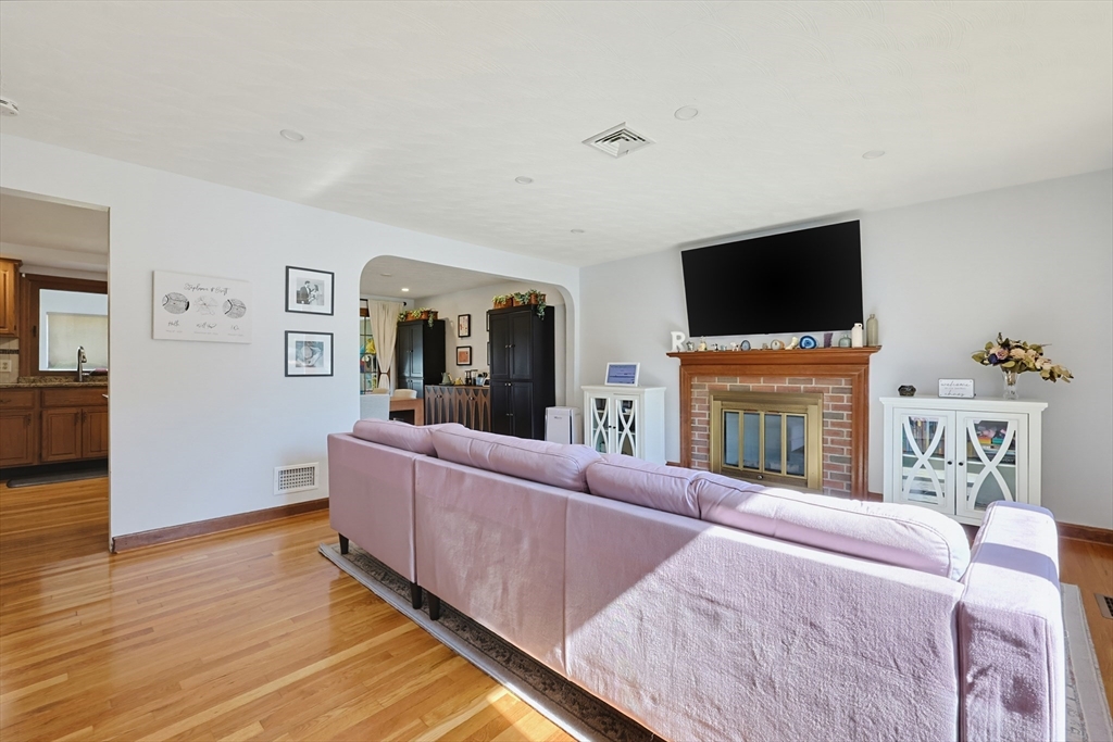 19 Weir Road Waltham, MA 02451 - Photo 12 of 41 a living room with fireplace furniture and a flat screen tv