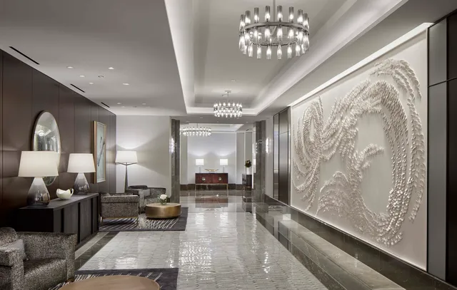 a lobby with furniture and a large mirror