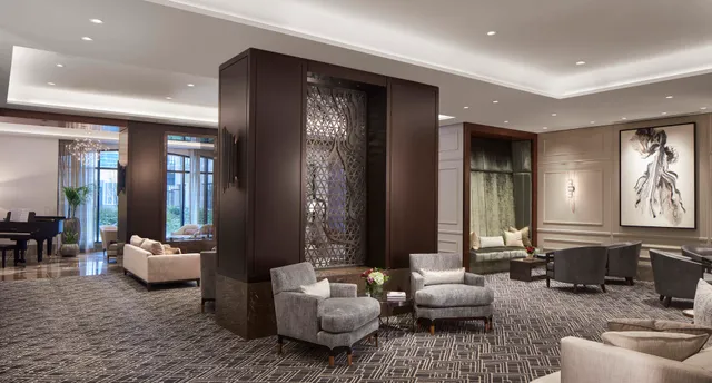 a living room with furniture and large windows