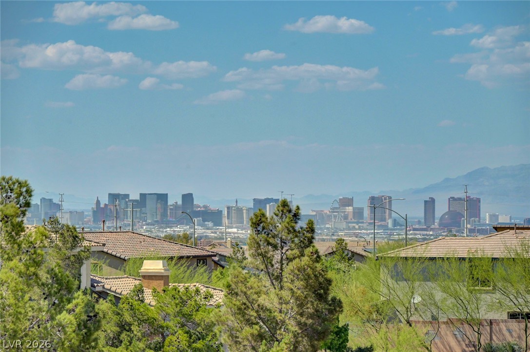 977 Sparkling Light Street Henderson, NV 89052 - Photo 8 of 75 Las Vegas STRIP Views from the Balcony off of the Primary Bedroom. City lights glimmer on the horizon, offering expansive views from this vibrant neighborhood.