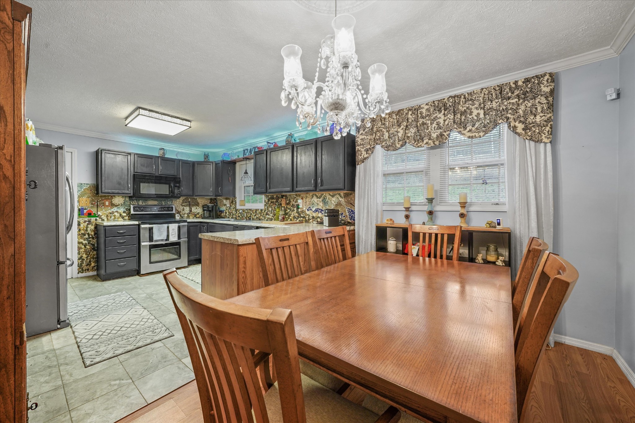 131 Scott Road Harriman, TN 37748 - Photo 20 of 51 a view of a dining room with furniture a chandelier and wooden floor