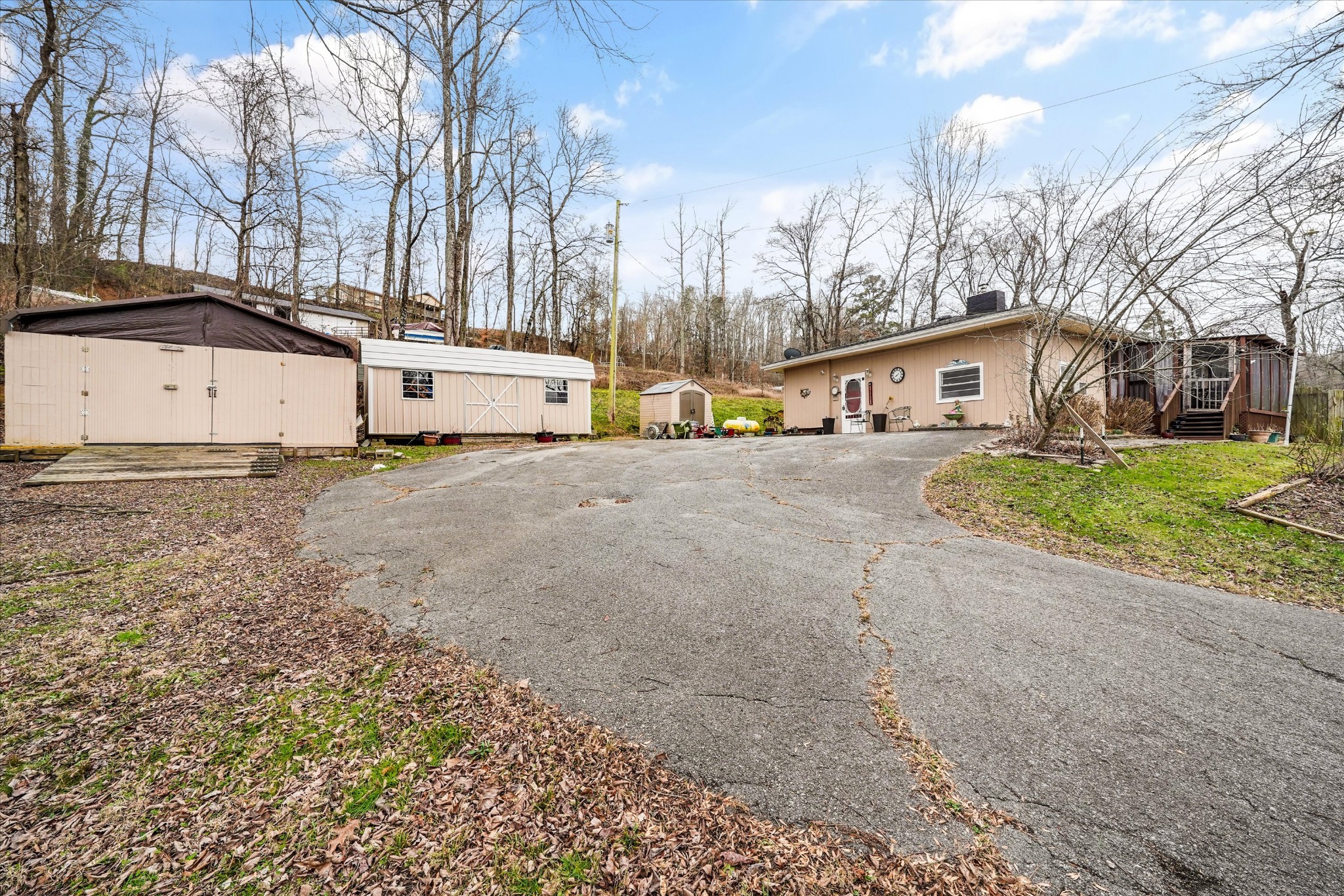 131 Scott Road Harriman, TN 37748 - Photo 42 of 51 a view of a white house with a yard and large tree