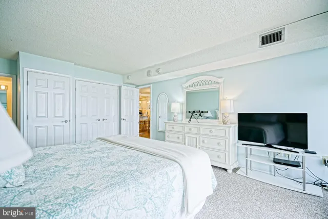 a bedroom with a flat screen tv and a bed