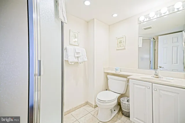 a bathroom with a toilet a sink and a mirror