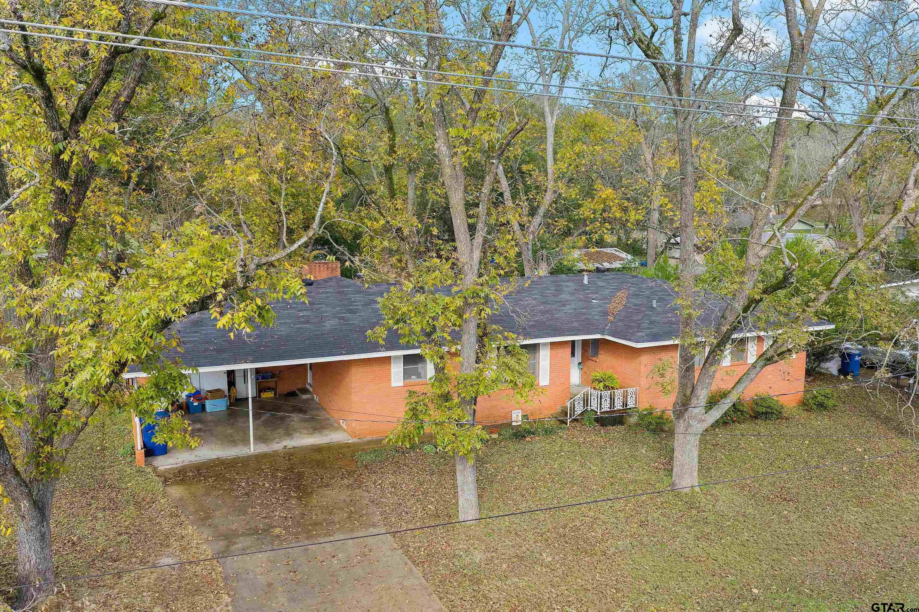 a view of a chairs and table in the backyard