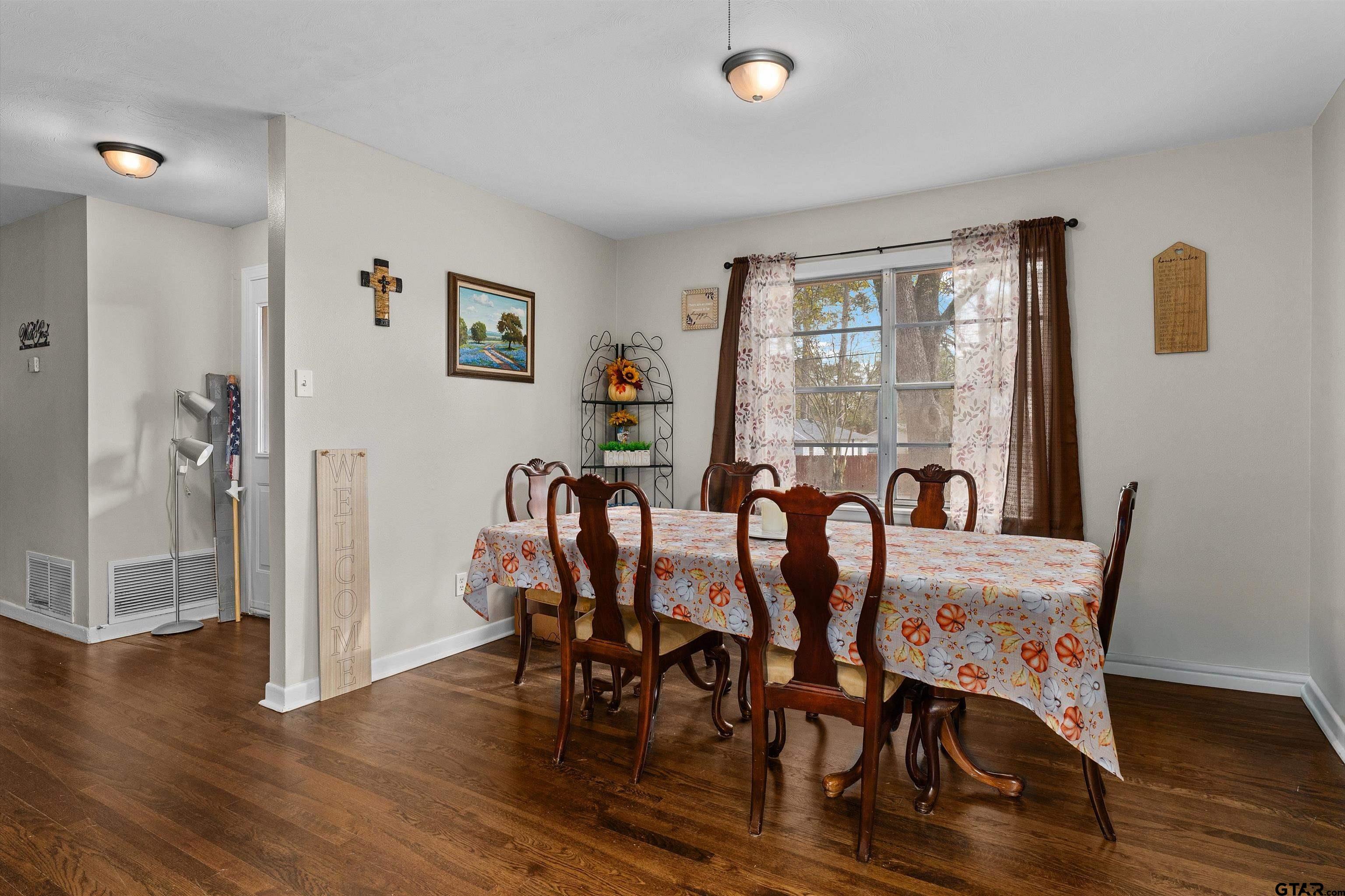 387 Hill Avenue Rusk, TX 75785 - Photo 16 of 26 a view of a a dining room with furniture window and wooden floor