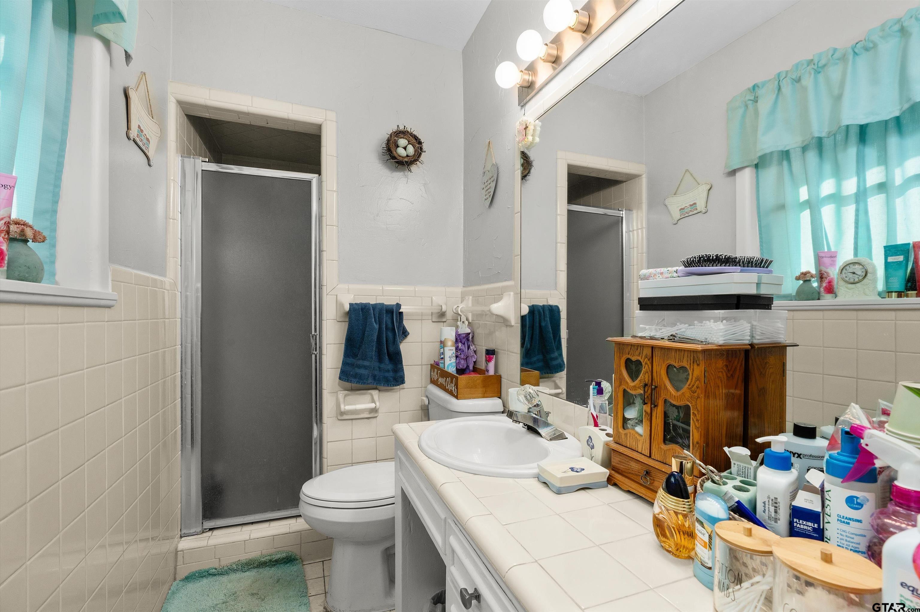 387 Hill Avenue Rusk, TX 75785 - Photo 21 of 26 a bathroom with a sink a toilet and shower curtain