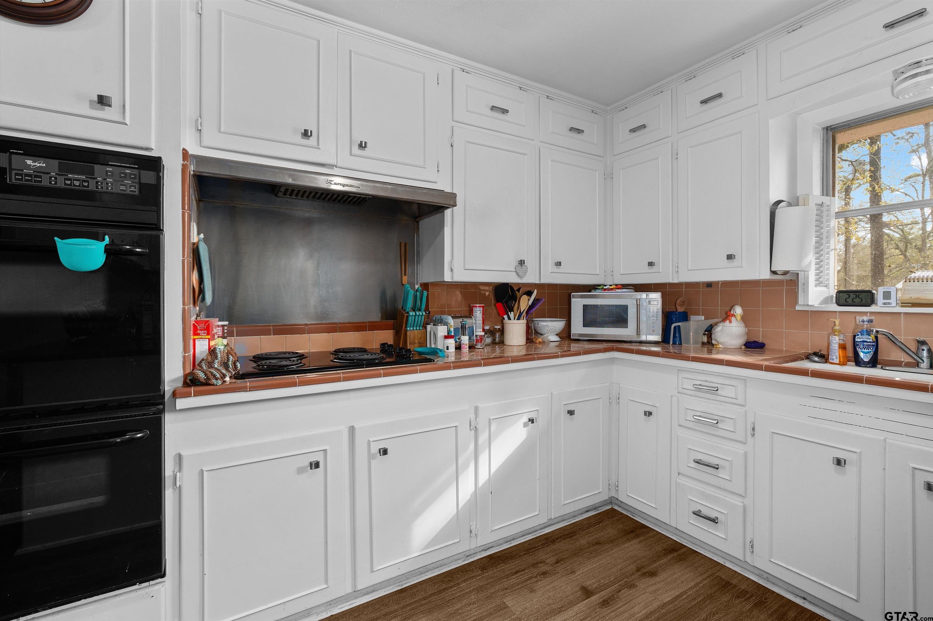 387 Hill Avenue Rusk, TX 75785 - Photo 10 of 26 a kitchen with white cabinets and sink