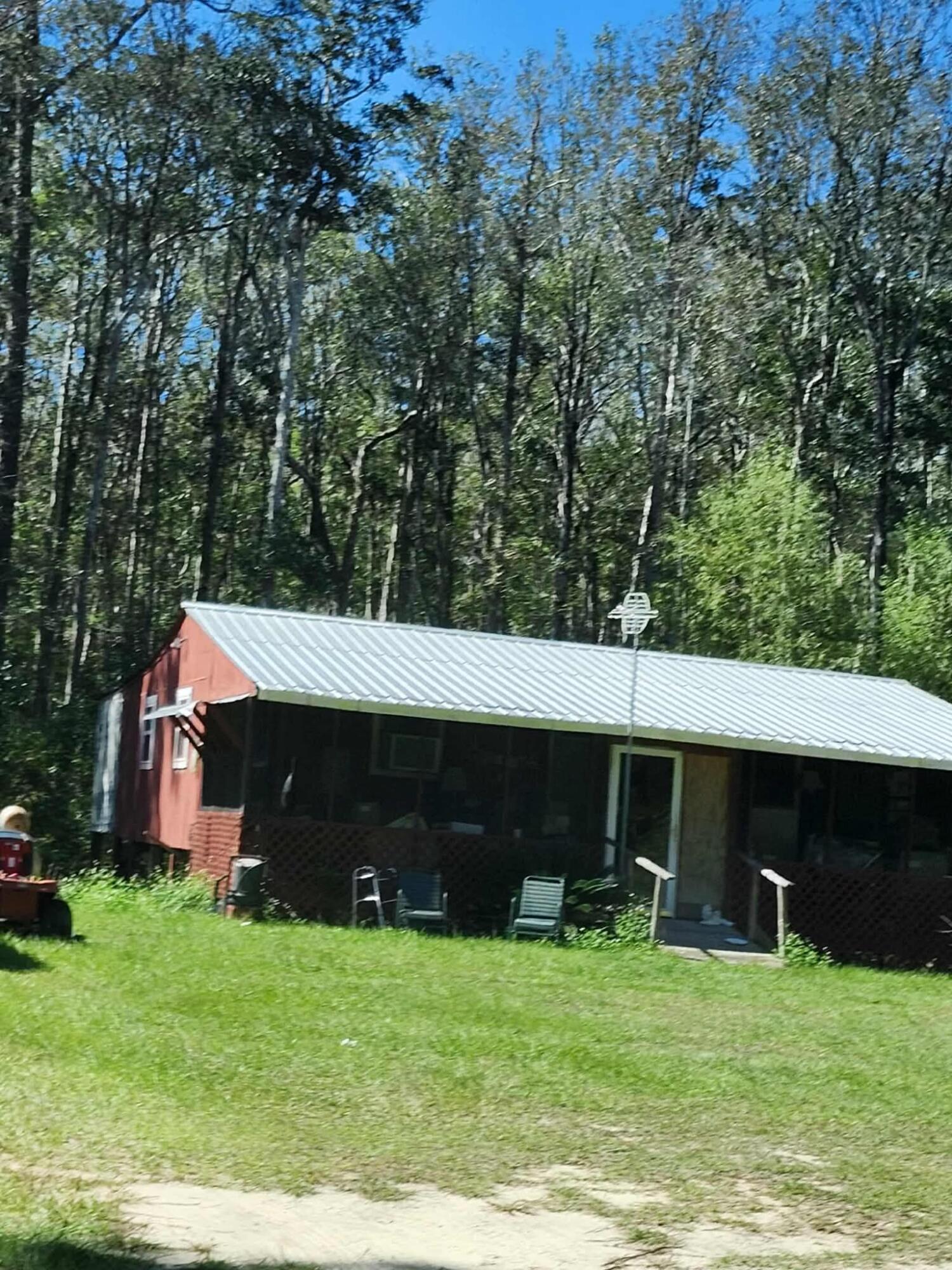 402 Smokehouse Lake Road Ponce de Leon, FL 32455 - Photo 1 of 13 a view of a house with backyard and a tree