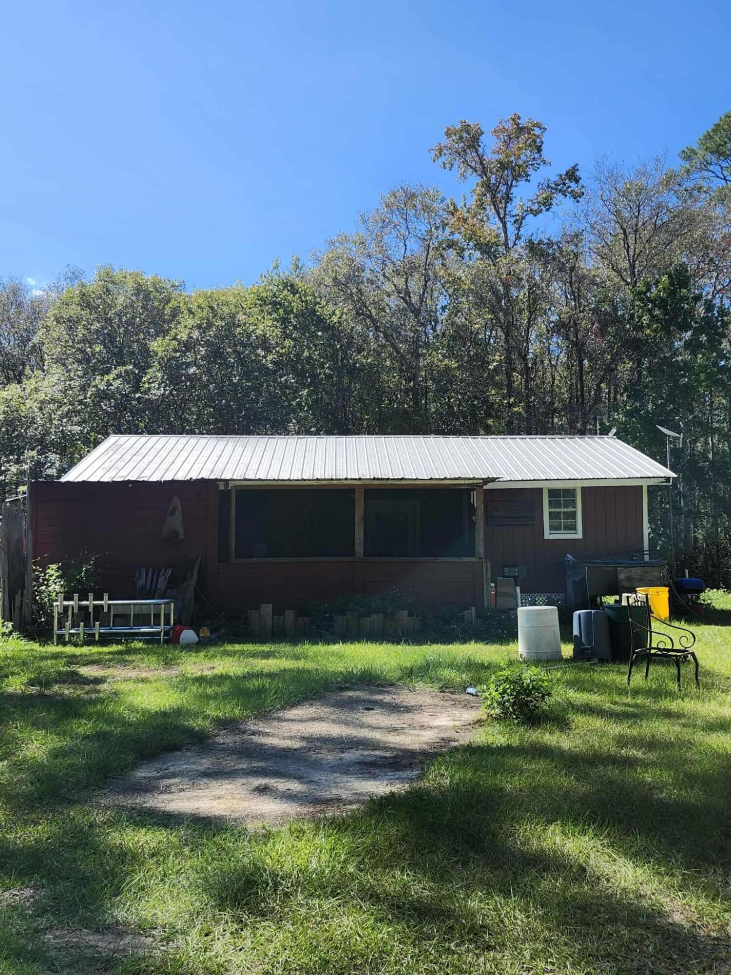 402 Smokehouse Lake Road Ponce de Leon, FL 32455 - Photo 2 of 13 a front view of a house with garden