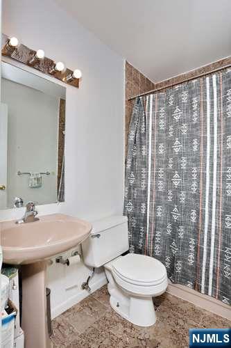 290 Hamilton Place, Unit 4 Hackensack, NJ 07601 - Photo 33 of 50 a bathroom with a sink toilet and shower