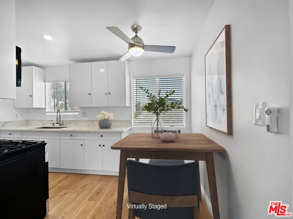 a kitchen with a sink cabinets and window