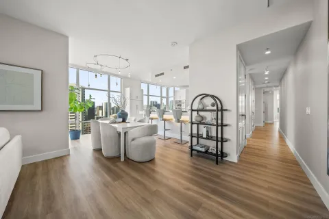 a living room with furniture wooden floor and a large window