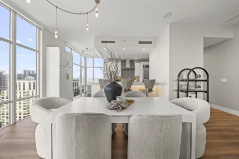 a view of kitchen with stainless steel appliances dining table and chairs