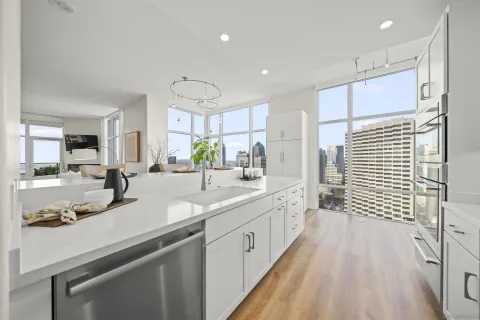 a large white kitchen with a large window