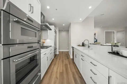 a large white kitchen with a large stove a sink and dishwasher