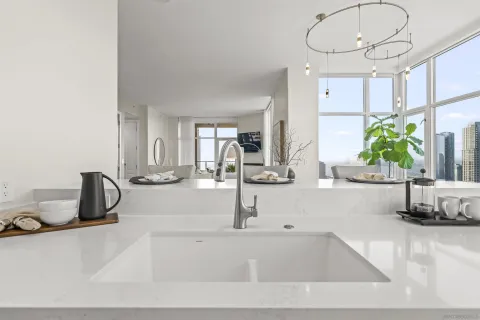 a kitchen with a faucet a sink and a view of living room