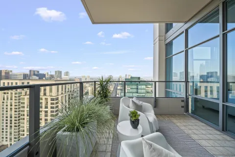 a balcony with furniture and a potted plant