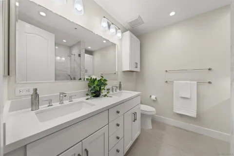 a bathroom with a sink a toilet and a mirror