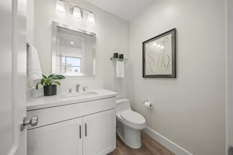 a bathroom with a toilet sink and mirror