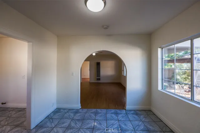 a view of entryway with window and wooden floor