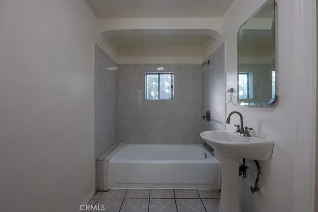 a white bath tub sitting next to a white sink