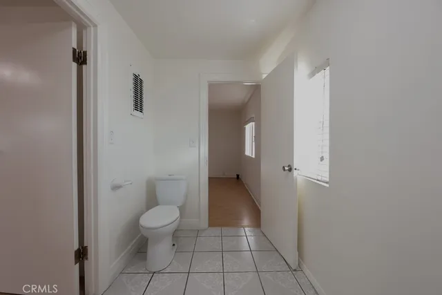 a bathroom with a granite countertop toilet and a sink
