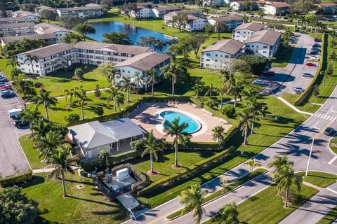an aerial view of a swimming pool with outdoor seating